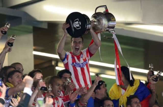 Atletico Madrid's midfielder and captain Gabi holds the trophy. Picture: AFP/Getty
