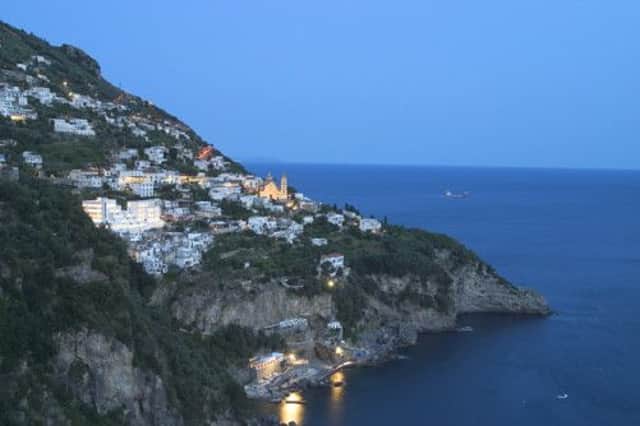 The Amalfi coast was described by Steinbeck as: houses climb a hill so steep it would be a cliff except that stairs are cut in it