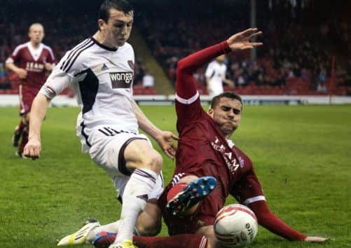 Hearts' David Smith  sees his cross closed down by Clark Robertson. Picture: SNS