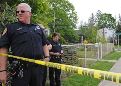 Officers guard the area near the crime scene. Picture: AP