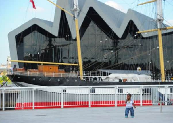 One-year-old Jemba Muqutali Adam stands in front of the Riverside Museum. Picture: Robert Perry/TSPL