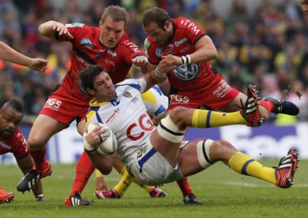 Nathan Hines is tackled by Toulon replacements Gethin Jenkins, left, and Frederic Michalak late in Saturdays final. Picture: Getty