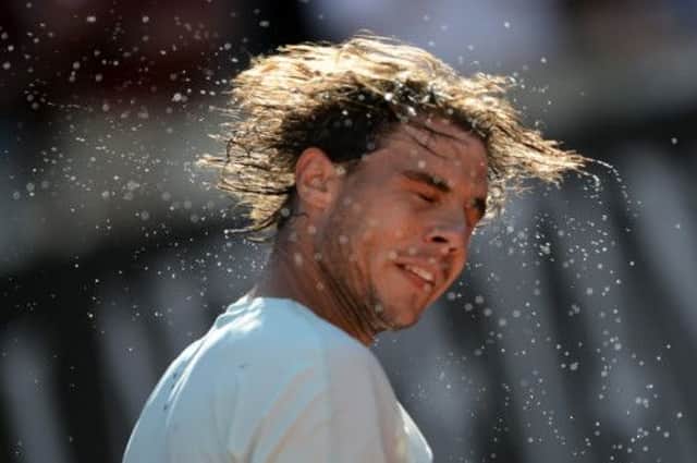Rafael Nadal gives himself a shake after easing to victory over Roger Federer yesterday. Picture: Getty