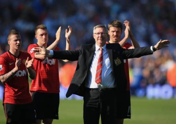 Sir Alex Ferguson takes the acclaim of the Manchester United players and supporters after his last match. Picture: Getty