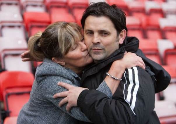 Alloa manager Paul Hartley gets a kiss from his mum after his side completed their play-off victory yesterday. Picture:PA