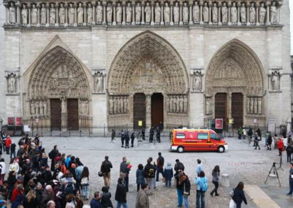 People gather as police cordon off the Notre Dame Cathedral in Paris. Picture: AP