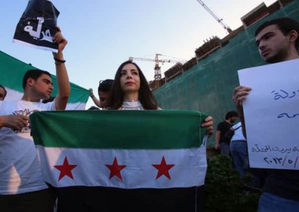 Lebanese and Syrians take part in a demonstration against Hezbollah's military interference in Syria. Picture: Getty