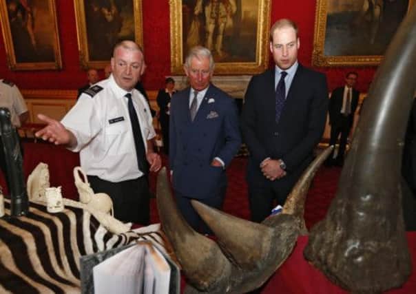 Prince Charles and Prince William view confiscated items. Picture: PA