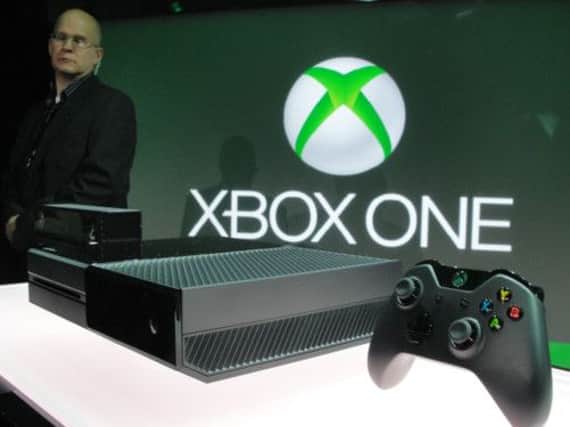 The new Microsoft Xbox One is watched by a security guard. Picture: AFP