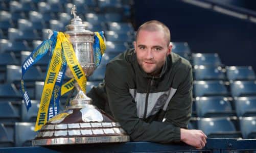 James McPake gets up close and personal with the trophy Hibs have failed to win for 111 years. Picture: Steve Welsh