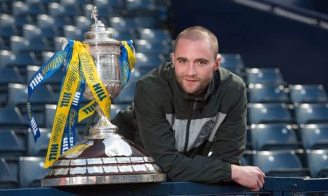 James McPake gets up close and personal with the trophy Hibs have failed to win for 111 years. Picture: Steve Welsh