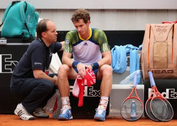 Andy Murray looks dejected as he talks to his trainer before pulling out of the Rome Masters. Picture: Getty
