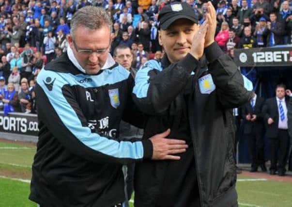 Paul Lambert and Stiliyan Petrov acknowledge the response from fans at Wigan on Sunday. Picture: PA