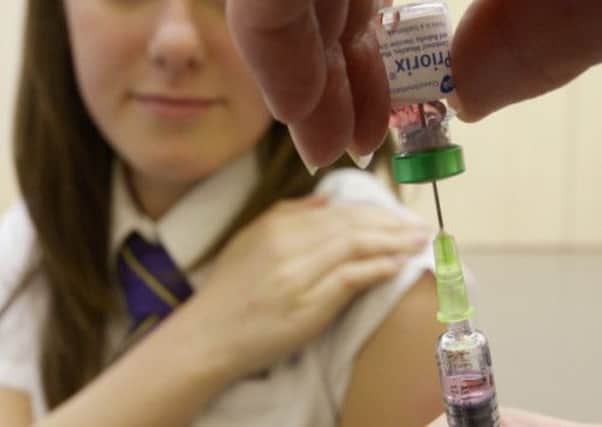 A schoolgirl gets ready to receive a measles jab. Picture: PA