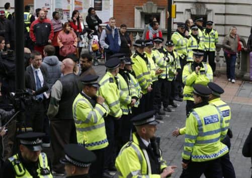 Police officers gather with crowds of media and the public near Woolwich town centre. Picture: Getty