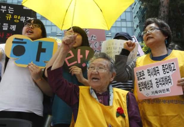 Kil Won-ok, centre, and supporters protest outside Japanese embassy in Seoul, South Korea . Picture: AP