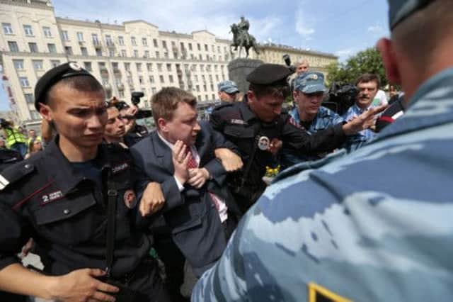 Police detain Russia's leading gay rights campaigner Nikolai Alexeyev during an unsanctioned gay rally in Moscow. Picture: AP