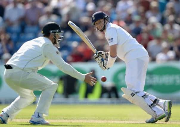Hamish Rutherford is unable to stop Joe Root getting the ball away as he headed for his century. Picture: Getty