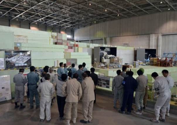 Local government officials investigate the inside of nuclear research lab J-PARC in Tokaimura, Ibaraki prefecture. Picture: AP