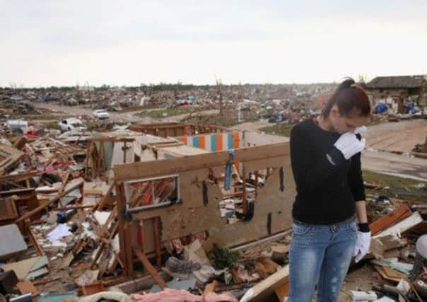 A resident of Moore, Oklahoma, examines the wreckage of her home after last weeks tornado. Picture: Getty