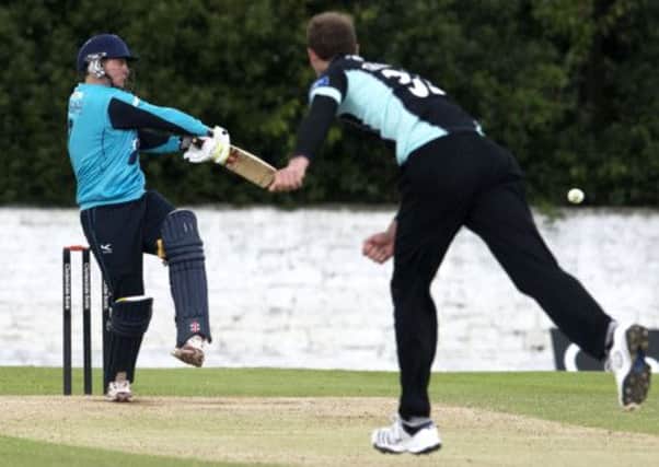 Surrey bowler Chris Tremlett bowls towards Ewan Chalmers. Picture: SNS