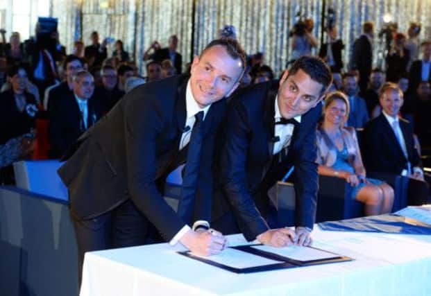 Vincent Aubin, left, and Bruno Boileau complete the paperwork at their wedding.  Picture: AFP/ Getty