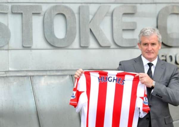 Mark Hughes is unveiled as the new Stoke City manager yesterday after signing a threeyear deal at the Britannia Stadium. Picture: PA