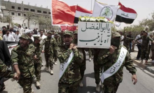 In a sign of the increasingly complex web of allegiances, an Iraqi Shiite, killed in clashes near Qusair, comes home. Picture: Reuters