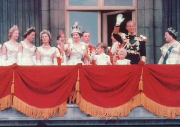 The Duke of Edinburgh and the newly crowned Queen Elizabeth II wave to the crowd from the balcony at Buckingham Palace. Picture: Getty