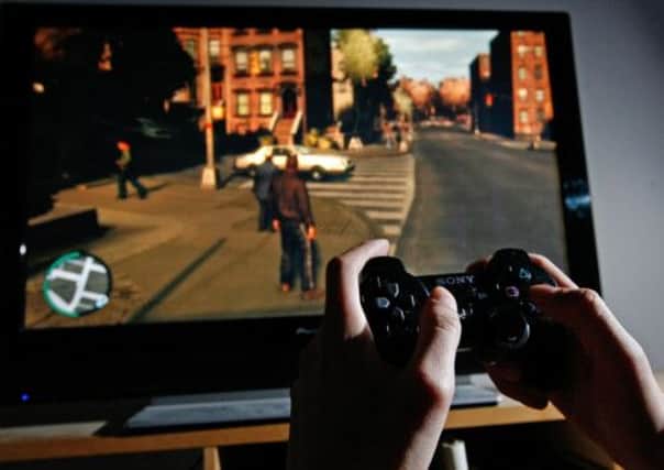 A young man plays Grand Theft Auto IV on the Sony Playstation 3. Picture: Getty