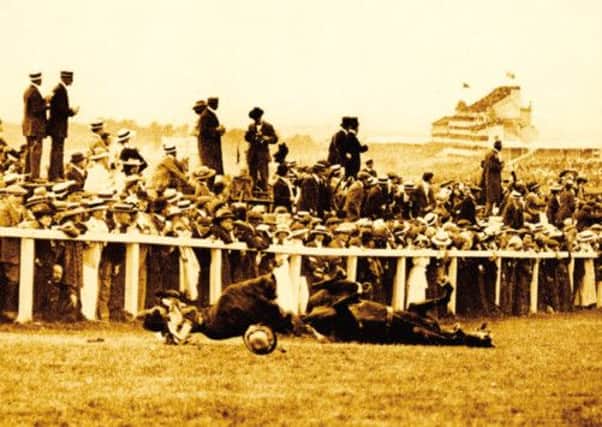 Emily Davison is fatally injured as she tries to stop the King's horse 'Amner' on Derby Day. Picture: Getty