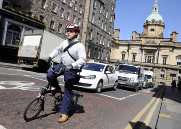 A cyclist pauses on George IV Bridge, in Edinburgh, one of the streets that would be shut off to cars and lorries if the proposal were to get the goahead. Picture: Greg Macvean