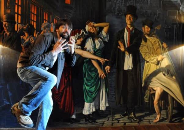 Joe Hill tries to step into the Burke & Hare mural by Mel Holmes at Edinburghs Hotel du Vin. Picture: Jane Barlow