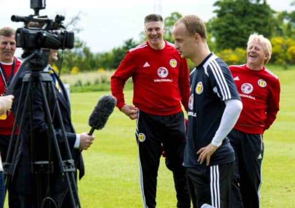 Leigh Griffiths puts a smile on the faces of Scotland manager Gordon Strachan and goalkeeping coach Jim Stewart at Mar Hall yesterday. Picture: SNS