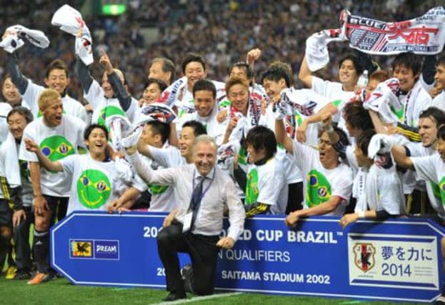 Japan coach Alberto Zaccheroni celebrates with his players after a 1-1 draw with Australia. Picture: AFP/Getty