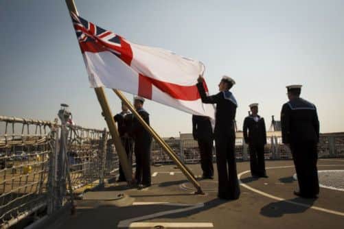 The white ensign is lowered for the last time as HMS Edinburgh is decommissioned. Picture: PA