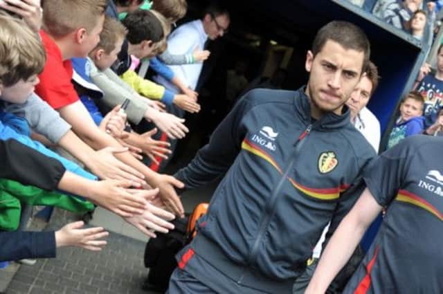 Belgium midfielder Eden Hazard arrives at training yesterday as the Group A leaders prepare to host Serbia tonight. Picture: AFP/Getty