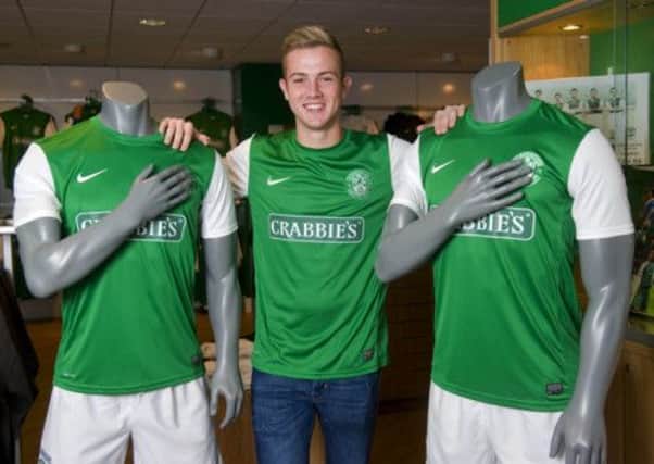 Hibs striker Danny Handling models the new kit in the club shop at Easter Road. Picture: SNS