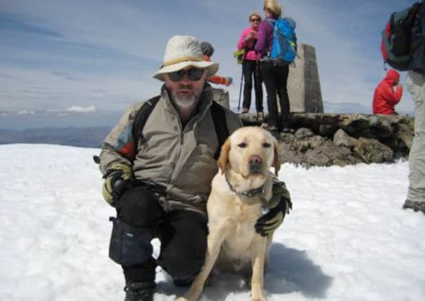 Miles Butcher reached the top of Ben Nevis, Britain's highest summit, with his guide dog. Picture: Malcolm Thomson