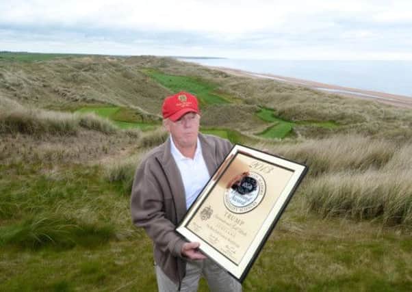 Donald Trump shows off his Six Star award for the best golf course from the American Academy of Hospitality Science. Picture: SWNS