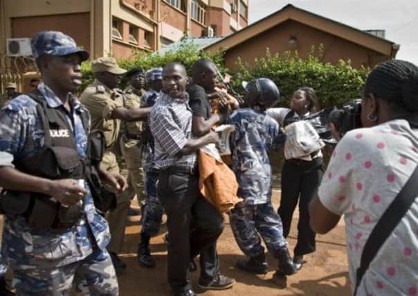 Media and campaigners struggle with police as they protest against the rule of Yoweri Museveni. Picture: AP