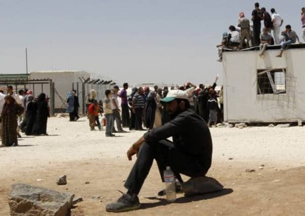 Syrian refugees wait to receive aid and rations at the Al Zaatri refugee camp on the Jordanian border. Picture: Reuters