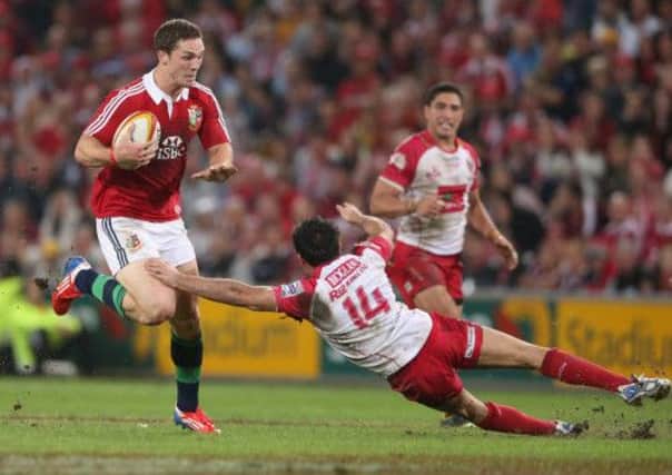 George North of the Lions moves past Rod Davies. Picture: Getty