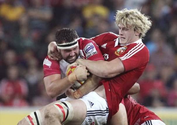Richie Gray of the Lions tackles James Hanson of the Reds. Picture: AP
