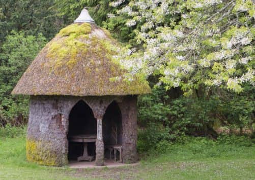Thatched 'Heather Hut' and cherry blossom