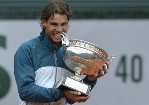 Rafael Nadal poses with the Musketeers trophy after winning the 2013 French tennis Open final. Picture: AFP