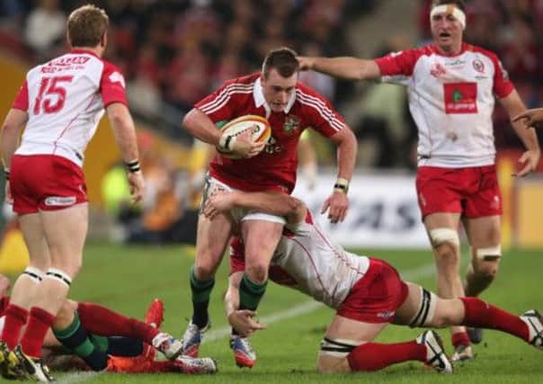 Stuart Hogg of the Lions is tackled by Eddie Quirk. Picture: Getty