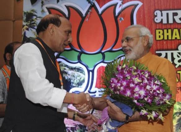 Narendra Modi, right, is greeted by BJP president Rajnath Singh during the partys national executive meeting at Panaji, Goa. Picture: AP