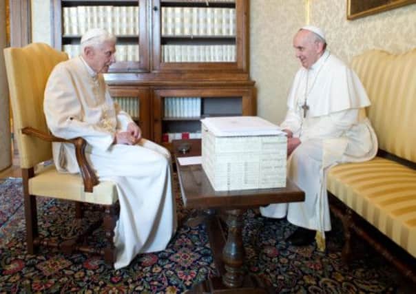 Pope emeritus Benedict XVI, left,  speaking to Pope Francis. Picture: Getty
