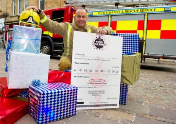 Fireman Wullie McIntosh is urging South Lanarkshire players to check their Christmas Day EuroMillions ticket. Picture: PA